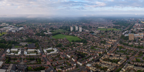 Obraz premium Panoramic aerial image of Hulme, Moss side and old Trafford suburb areas of Manchester UK in the morning. 