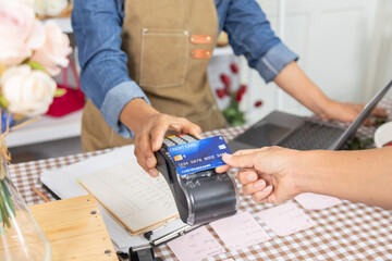 Asian senior woman, florist, small business, owner, entrepreneur receiving cashless payment via credit card terminal, representing modern service, smile, lifestyle and retail store, 60s retirement