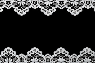 Delicate white lace border with floral pattern on black background trim fabric
