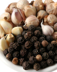 Garlic and black peppercorns in a bowl a fragrant spice blend,