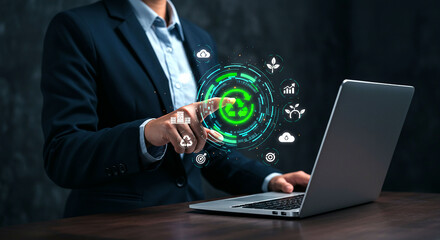 Person using a laptop and touching a holographic recycling symbol with environmental icons around it