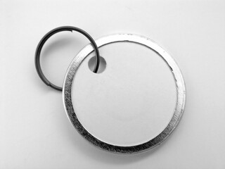 Minimalist Black and White Image of a Metal Keyring with a Round Tag, Perfect for Adding Text or a...
