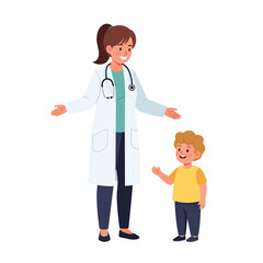 Fototapeta premium Smiling female pediatrician interacts with a happy young boy during a checkup.