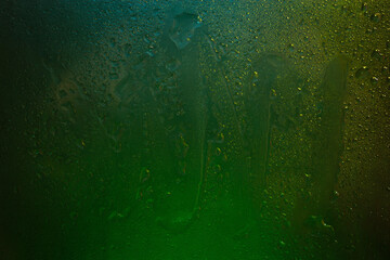 Wet glass. Drops of water on dark glass. Abstract texture. Multicolored spots