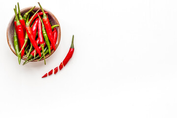 Cooking hot food with chilli pepper on white table background top view copy space