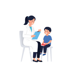 A female doctor sits with a young boy, holding a clipboard, during a consultation.