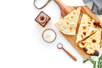 Italian focaccia with cheese and rosemary on white background top-down copy space