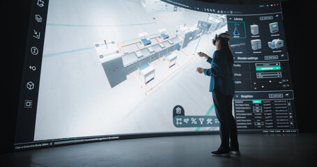 Female Designer in Virtual Reality Headset Expertly Crafts an Automated Factory Layout on a Large...