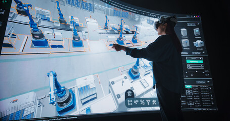 Manufacturing Female Engineer in VR Headset Optimizes Production Flow in a Simulated Factory...