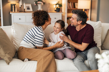 Happy Family Sharing a Joyful Moment at Home in a Cozy Living Room