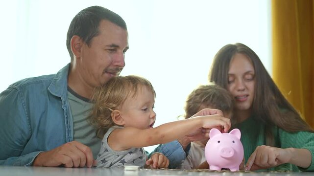 Mother teaching child about budget with piggybank. Family saving coins in piggybank. Child learn financial responsibility. Budget planning concept with piggybank. Mother guides child saving with piggy