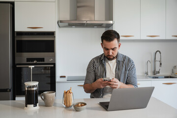  Man Working from Home with Coffee and Snacks in Modern Kitchen