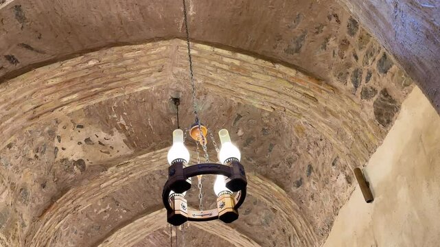 Chandelier in restaurant desert architectural design in Iran Persian Arabian culture of local ancient brick dome ceiling landmark historic interior decoration and vaulted roof religious vintage temple