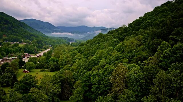 Aerial cinematic pass through the foggy Smoky Mountains.
