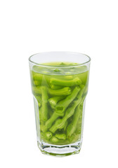 Green beans submerged in clear liquid within a transparent glass, on a black background