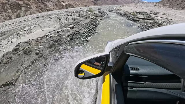 Car drive along creek in Ladakh region