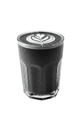 Black latte in clear glass, with latte art on top, dark liquid, and condensation