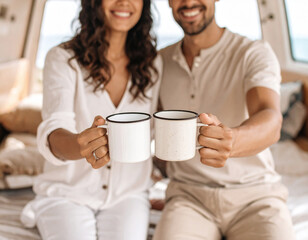 Photo realistic. Close up view of van life couple. Happy couple in beige natural clothing smiling, sit on van wood furniture looking out the back of the van. Van is by the sea on sand. 