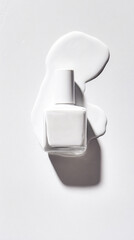 White Nail Polish Bottle and Spill on White Surface