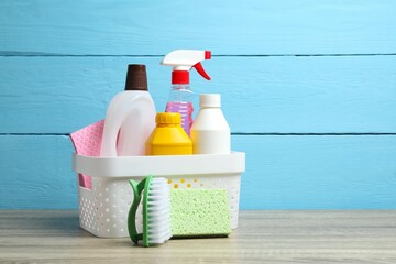 Cleaning supplies in basket on the table, with brushes, spray bottles, sponge. Ideal for...