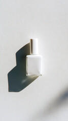 Square White Bottle on Textured White Background with Shadow