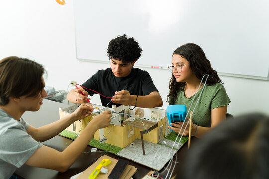 High school students working on smart home electronics project for stem class