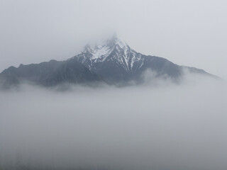 Enigmatic Mountain Peak shrouded in Mist A Serene Landscape Photography