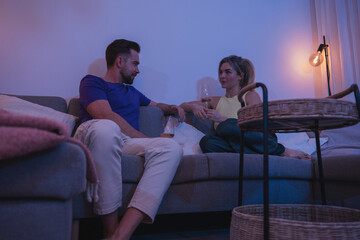 Relaxed Couple Enjoying Wine at Home in the Evening