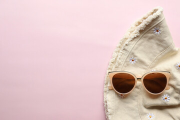 Sunglasses on a plain background. Summer, chamomile