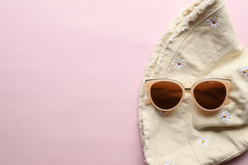 Sunglasses on a plain background. Summer, chamomile