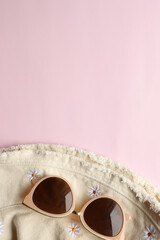 Sunglasses on a plain background. Summer, chamomile