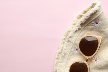 Sunglasses on a plain background. Summer, chamomile