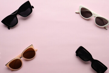 Sunglasses on a plain background. Summer, chamomile
