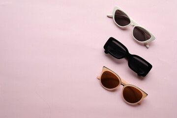 Sunglasses on a plain background. Summer, chamomile