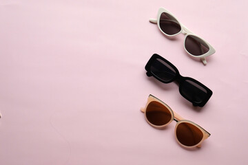 Sunglasses on a plain background. Summer, chamomile