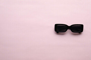 Sunglasses on a plain background. Summer, chamomile