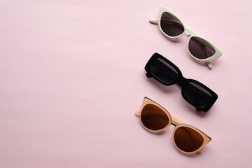 Sunglasses on a plain background. Summer, chamomile