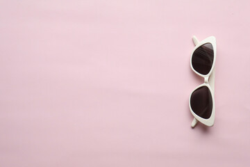 Sunglasses on a plain background. Summer, chamomile