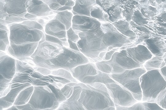 Close-up of a white water texture with ripples and waves, isolated on a grey background, top view