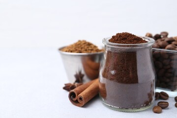 Different types of instant coffee, beans and spices on light table, closeup. Space for text