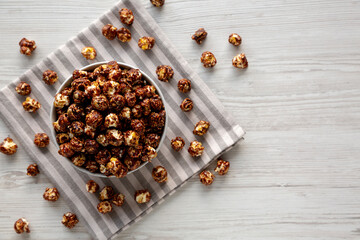 Homemade Chocolate Caramel Popcorn Ready to Eat in a Bowl, top view. Copy space.