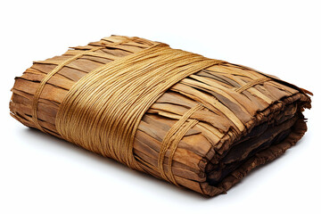 Rectangle bundle tied with rope, wrapped in layered woven dried leaves, sits against a white background