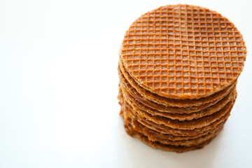 Dutch stroopwafels  (Dutch caramel waffle) stacked on white background, top view