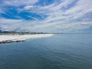 Mexico Beach at Canal Parkway, looking east toward the Gulf of Mexico, pristine white sand, and calm surf.
