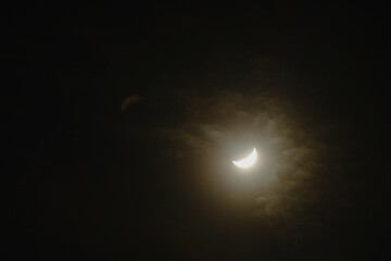 half moon covering by cloud floating on sky in night background