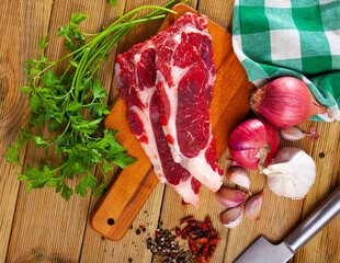 Image of raw veal with greens and spice before cooking, nobody