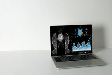 Artificial Intelligence (AI) and Machine Learning concept. Laptop screen displays a futuristic...