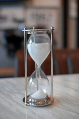 hourglass on a black background. Sandglass, hourglass or egg timer with shadow showing the last...