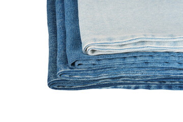 Pile of folded textile, various shades of blue jeans fabric isolated on white, transparent...
