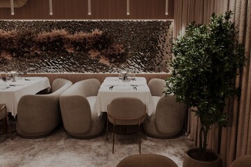 Modern restaurant corner with textured wall and cozy armchairs